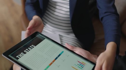 close up multi ethnic business people in professional corporate meeting browsing financial graph statistics viewing market research charts on tablet screen technology - Powered by Adobe