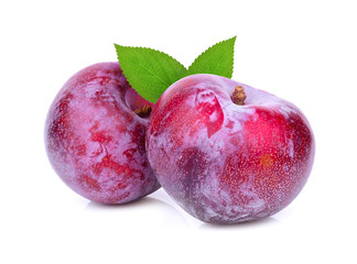red plum with green leaves isolated on white background