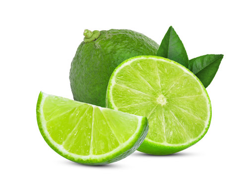 whole and slice green lime with green leaves isolated on white background
