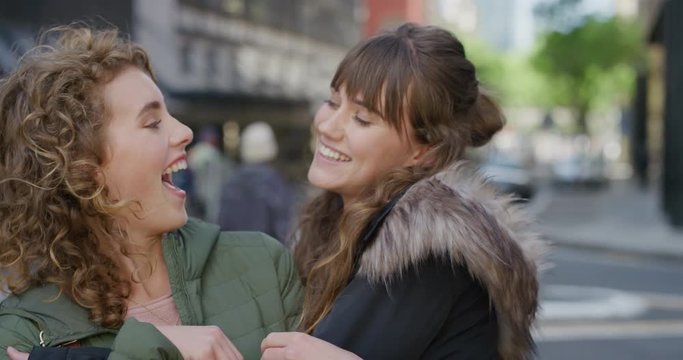 Portrait Young Woman Surprise Kiss Girlfriend Embracing Smiling Cheerful Couple Enjoying Friendship Best Friends Hugging Having Fun In Urban City Street Real People Series