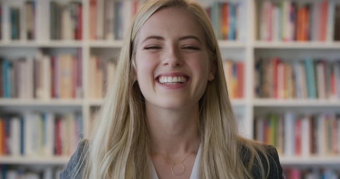 portrait beautiful happy blonde woman student laughing enjoying successful independent lifestyle cheerful young female entrepreneur in library bookstore background
