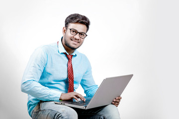 Young indian male using laptop