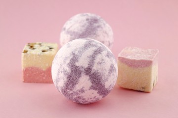 Lavender bath bombs and a truffle for a bath on a  pink background.Aromatherapy and body cosmetics.natural organic body cosmetics