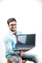 Young indian showing laptop screen