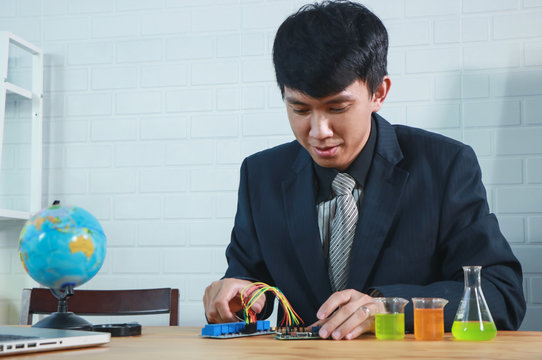 STEM education Laboratory. man coding a meta program it on the computer.electronic board that can be programmed.technology,Mathematics. science. engineering.