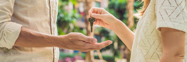 Real estate agent giving keys to apartment owner, buying selling property business. Close up of...