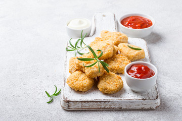 Fried crispy chicken nuggets with popular sauces