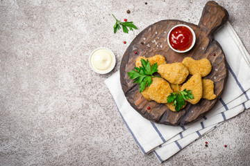 Fried crispy chicken nuggets with popular sauces