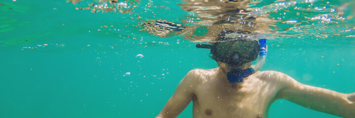 A young caucasian snorkeling man under water selfie Thailand BANNER, long format