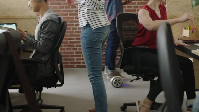 young multi ethnic business team in lively office workspace diverse employees interacting enjoying relaxed startup workplace