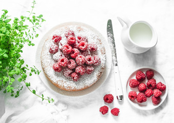Simple butter cake with raspberry on light background, top view. Delicious summer dessert. Flat lay
