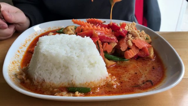 Eating asian vegetables with tofu and rice