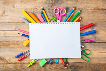 Back to school. School supplies and blank notebook on wooden background, space for text
