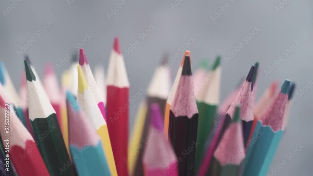 Poster colored pencils, rotation 360 degrees. dark bacground. macro view.