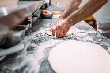 Chef preparing pizza dough. - obrazy, fototapety, plakaty