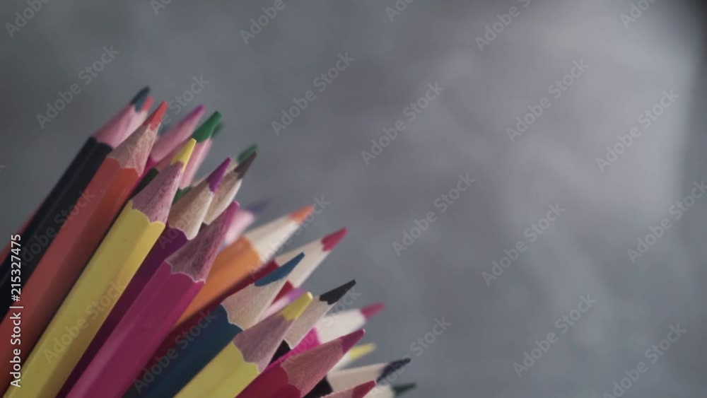 Poster colored pencils, rotation 360 degrees. dark bacground. macro view.