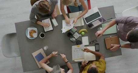 top view professional business team working on corporate project brainstorming innovative ideas for successful strategy using graph data in modern office boardroom top view - Powered by Adobe