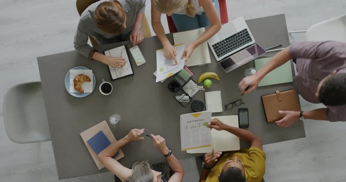 top view professional business team working on corporate project brainstorming innovative ideas for successful strategy using graph data in modern office boardroom top view