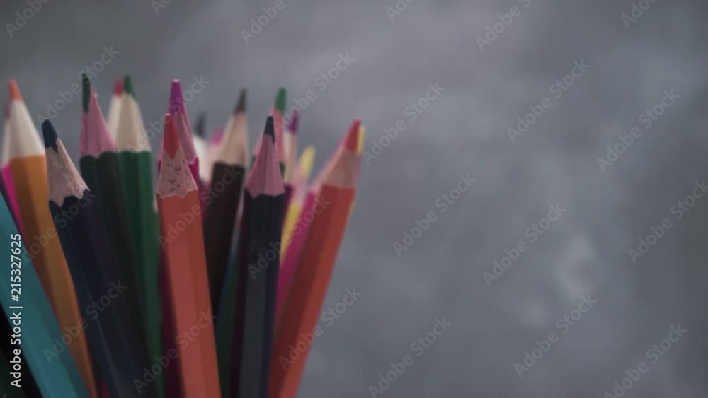 Poster colored pencils, rotation 360 degrees. dark bacground. macro view.