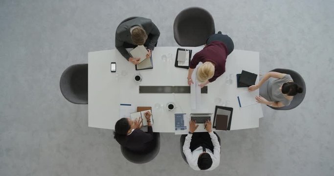 professional business people architects looking at building floor plan sharing ideas developing creative ideas for corporate architecture project in boardroom meeting top view