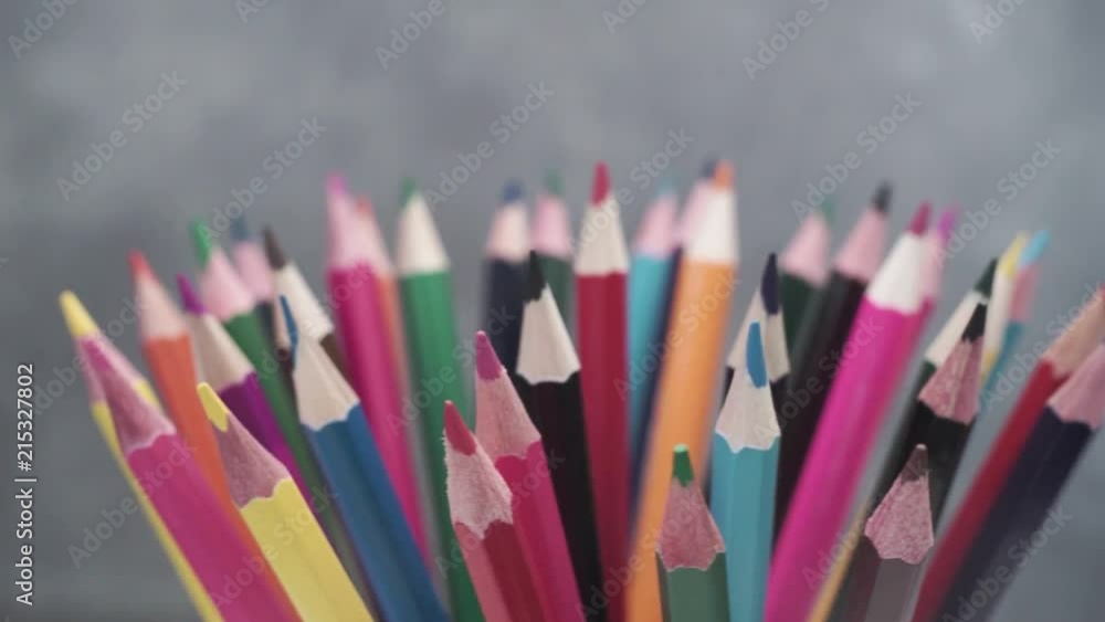 Poster colored pencils, rotation 360 degrees. dark bacground. macro view.