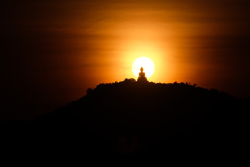 Obraz premium Silhouette buddha sunset warm lansscape