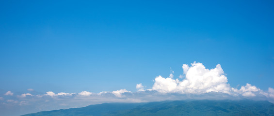 Fototapeta na wymiar blue sky and mountain in background.