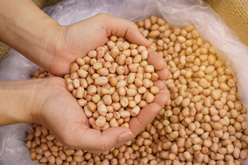 bag of peanuts with hands