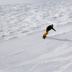 Ski slope and snowboarder at winter cold day