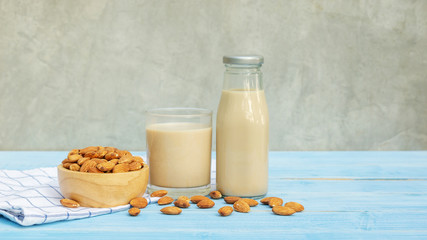 Almond milk on a blue wooden table.