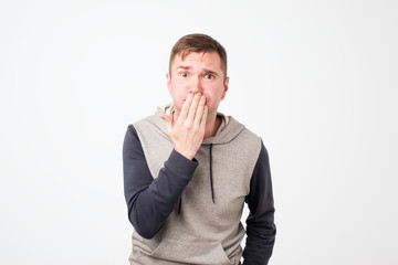 Nausea aversion repulsion. European young handsome man grimacing in disgust.