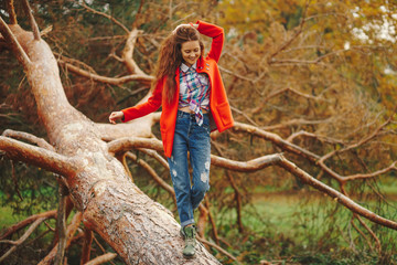 Fashionable girl walking happy in the park