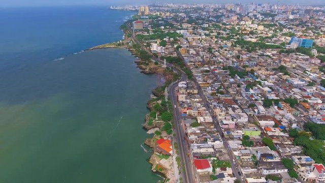 Bird's Eye Aerial Shot of Santo Domingo's malecon with ocean and the city