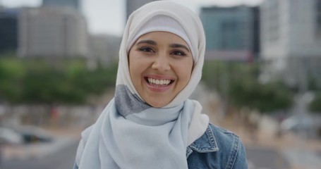 portrait young beautiful muslim woman laughing enjoying successful urban lifestyle independent female student wearing hijab headscarf in city wind blowing - Powered by Adobe