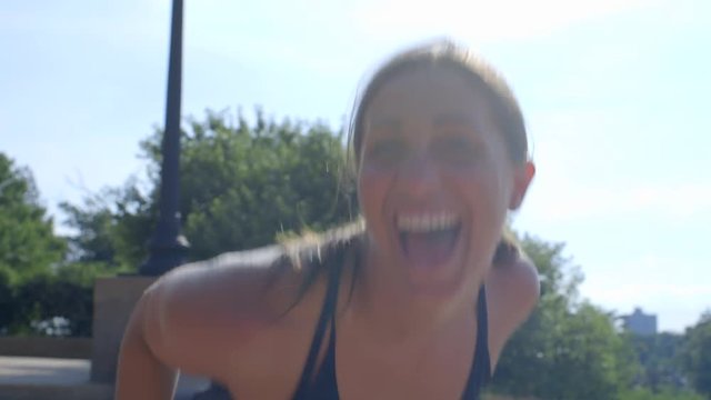 Millenial Girl training in Forest Park makes silly faces at the camera