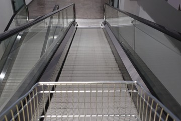 Closeup of escalator in department store for customer use in case they have a lot of products