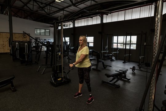 Woman exercising on machine in the gym
