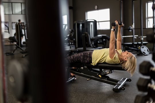 Woman exercising on machine in the gym