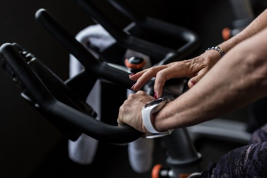 Close up of woman exercising on gym cycle