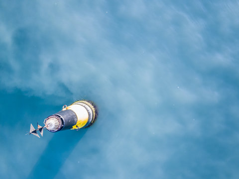 aerial top view from above sea buoy isolated in a water wave surface safety concept with copy space design