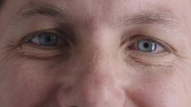 close up man blue eyes looking blinking happy caucasian male healthy eyesight satisfaction