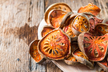 Dry Bael fruit - Slices of dry Bael fruit on the wooden table