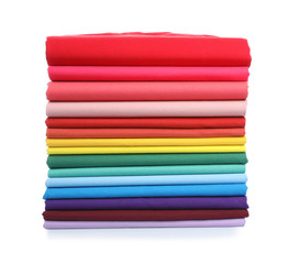 Pile of colorful t-shirts on white background