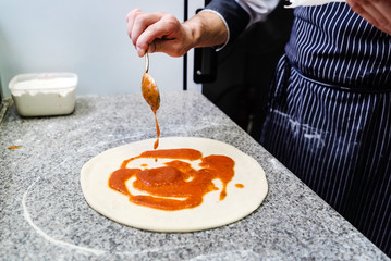 chef making pizza