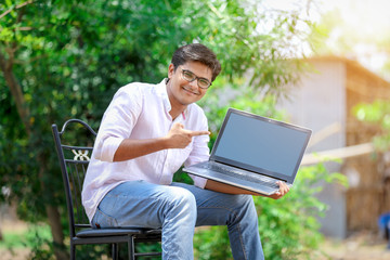 young Indian man using laptop , Working on Laptop