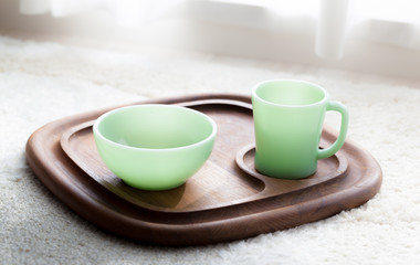 Fototapeta na wymiar Vintage mug and bowl on teak tray