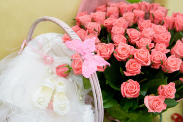 Basket with small children's white booties with ruffles for girls.