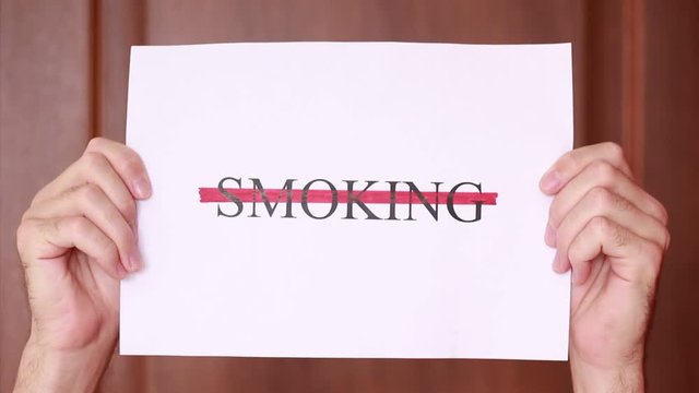 Holding "Smoking" inscription stricked through with red line