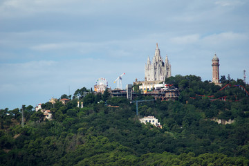 BARCELONA, SPAIN - AUG 30th, 2017: Panoramic view of the city Tibidabo Mountain in far distance from the bunkers de carmel on a cloudy day