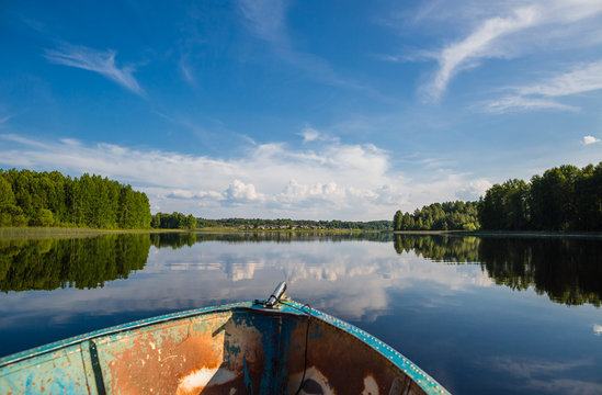 View from a boat on a lake in wild Russian land. Clouds and reflections.
